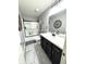 Bright bathroom featuring a white marble countertop, dark cabinets, tiled floors, and a shower with glass doors at 2936 W Calimanco Ln, Monrovia, IN 46157