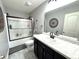 Bathroom featuring a white marble countertop, dark cabinets, tiled floors, and a shower with glass doors at 2936 W Calimanco Ln, Monrovia, IN 46157