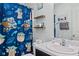 Full bathroom includes a 'Baby Yoda' shower curtain, marble countertop, and floating shelves at 2936 W Calimanco Ln, Monrovia, IN 46157