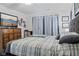 Bright bedroom features a ceiling fan, dresser with a TV, and a large window with decorative curtains at 2936 W Calimanco Ln, Monrovia, IN 46157