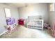 Cozy bedroom featuring a crib, soft carpet, and calming decor, ideal for a Bedroom or room at 2936 W Calimanco Ln, Monrovia, IN 46157
