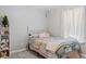 This bedroom has a white bed, pastel colored bedding, and a storage shelf with shoes on it at 2936 W Calimanco Ln, Monrovia, IN 46157