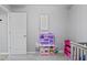 Bedroom with gray walls includes a toy kitchen, wall art, and access to the rest of the home at 2936 W Calimanco Ln, Monrovia, IN 46157