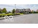 Community clubhouse with well-maintained lawn, landscaping, and convenient parking spaces at 2936 W Calimanco Ln, Monrovia, IN 46157