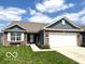 Charming single-story home featuring blue vinyl siding, brick accents, a well-manicured lawn and attached two-car garage at 2936 W Calimanco Ln, Monrovia, IN 46157