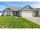 Charming single-story home features brick and siding exterior, attached two-car garage, and well-manicured lawn at 2936 W Calimanco Ln, Monrovia, IN 46157
