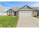 Charming single-story home features brick and siding exterior, attached two-car garage, and well-manicured lawn at 2936 W Calimanco Ln, Monrovia, IN 46157