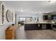 Modern kitchen featuring stainless steel appliances, dark cabinetry, marble counters, and open living space at 2936 W Calimanco Ln, Monrovia, IN 46157