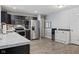 Modern kitchen features stainless steel appliances, dark cabinetry, and white countertops at 2936 W Calimanco Ln, Monrovia, IN 46157