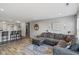 Open-concept living area with wood flooring, gray walls, and a comfortable sectional couch and open to the kitchen at 2936 W Calimanco Ln, Monrovia, IN 46157