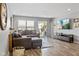 Cozy living room featuring wood-look floors, large sectional couch, entertainment center and sliding doors to patio at 2936 W Calimanco Ln, Monrovia, IN 46157