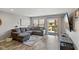 Cozy living room featuring wood-look floors, large sectional couch, entertainment center and sliding doors to patio at 2936 W Calimanco Ln, Monrovia, IN 46157