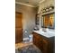 This well-lit bathroom has a wood vanity with ample storage, a toilet and a large mirror at 300 E Monroe St, Franklin, IN 46131