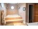 Luxurious bathroom with a large soaking tub, tiled steps, and natural light at 300 E Monroe St, Franklin, IN 46131