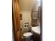 A lovely powder room featuring decorative wallpaper, built-in shelves, and a wood door at 300 E Monroe St, Franklin, IN 46131