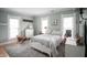 Cozy bedroom with two large windows, neutral tones, and comfortable furnishings at 300 E Monroe St, Franklin, IN 46131