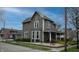 Charming two-story home with landscaped yard and inviting front porch at 300 E Monroe St, Franklin, IN 46131