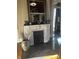 A living room featuring a decorative fireplace with a mirror and modern chandelier on hardwood floors at 300 E Monroe St, Franklin, IN 46131