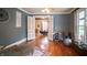 Open living room with double doors to dining area and beautiful hardwood floors at 300 E Monroe St, Franklin, IN 46131