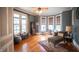 Sunlit living room with hardwood floors, bay windows, and stylish chaise lounge at 300 E Monroe St, Franklin, IN 46131
