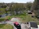 Aerial view of a home with a pond and red truck, showcasing the property's natural surroundings at 3311 Stella St, Greenwood, IN 46143