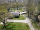Aerial view of a charming home with a well-maintained yard and a pond in a serene neighborhood at 3311 Stella St, Greenwood, IN 46143