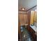 Bathroom featuring tile flooring, a shower with curtain, and wood cabinetry at 3311 Stella St, Greenwood, IN 46143