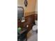 Bathroom featuring wood paneled walls, a toilet, and a decorative statue at 3311 Stella St, Greenwood, IN 46143