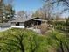 Home with covered porch surrounded by green grass and trees providing ample shade during the day at 3311 Stella St, Greenwood, IN 46143