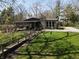 Charming home with a screened porch, stone chimney, and a walkway leading to the well-manicured yard at 3311 Stella St, Greenwood, IN 46143