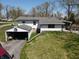 Two-story home with white siding, detached garage, and a spacious lawn, perfect for outdoor activities at 3311 Stella St, Greenwood, IN 46143