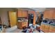 Functional kitchen with wood cabinets, a black refrigerator, and space for dining at 3311 Stella St, Greenwood, IN 46143
