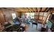 Living area with exposed beams, some windows, and a variety of stored items at 3311 Stella St, Greenwood, IN 46143
