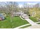 Aerial shot of a ranch style house with mature trees, a well kept lawn, and an attached two car garage at 334 Stonehedge Dr, Carmel, IN 46032
