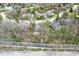 Aerial view showcasing a home tucked among mature trees with a well-maintained yard at 334 Stonehedge Dr, Carmel, IN 46032