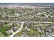 Wide aerial perspective featuring a cluster of houses, trees, and a view of city buildings in the distance at 334 Stonehedge Dr, Carmel, IN 46032