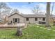 This backyard features a spacious deck, lush green lawn, stone pathway, and relaxing hot tub at 334 Stonehedge Dr, Carmel, IN 46032