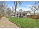 Spacious backyard with mature trees, a deck, a hot tub, and a charming stone pathway at 334 Stonehedge Dr, Carmel, IN 46032