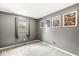 Empty gray bedroom with window and wall art at 334 Stonehedge Dr, Carmel, IN 46032