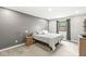 Bedroom featuring gray walls, gray carpet, a window, and bedside table with a lamp at 334 Stonehedge Dr, Carmel, IN 46032
