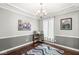 Dining room with decorative trim and accents, dark-stained hardwood floors, and designer chandelier at 334 Stonehedge Dr, Carmel, IN 46032