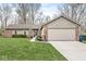 Charming single-story home featuring brick and siding exterior, well-manicured lawn, and attached two-car garage at 334 Stonehedge Dr, Carmel, IN 46032