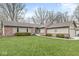 Beautifully maintained single-story house with a lush green lawn, brick accents, and a welcoming front entrance at 334 Stonehedge Dr, Carmel, IN 46032