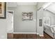 Entryway showcasing hardwood floors, neutral walls, and an elegant mirror enhancing the open and airy ambiance at 334 Stonehedge Dr, Carmel, IN 46032