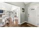 Inviting foyer with hardwood floors, white trim, and a glimpse into the spacious living area with fireplace at 334 Stonehedge Dr, Carmel, IN 46032