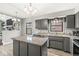 Open concept kitchen with center island, granite countertops, and views of a gas brick fireplace at 334 Stonehedge Dr, Carmel, IN 46032