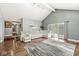 Open living room with hardwood floors, cathedral ceiling, and a sliding glass door that brings in lots of natural light at 334 Stonehedge Dr, Carmel, IN 46032
