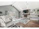 Spacious living room features a cozy fireplace, skylights, and access to the outdoor patio, perfect for relaxing at 334 Stonehedge Dr, Carmel, IN 46032