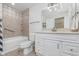 Bright bathroom with single sink vanity, a combination shower-tub and decorative tile at 3462 Briar Creek Ln, Carmel, IN 46033