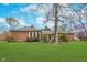 Charming brick ranch home featuring mature trees and a lush green lawn at 3462 Briar Creek Ln, Carmel, IN 46033